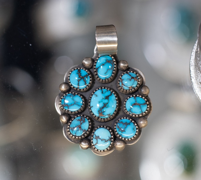 Silver pendant with cluster of turquoise stones